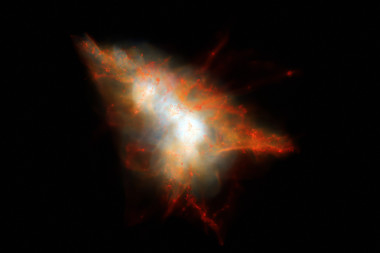 <p>Instantánea de una simulación cosmológica de una mancha Lyman-alfa similar a LAB-1. Incrustadas en el centro de este sistema hay dos galaxias con fuerte formación estelar, pero están rodeadas por gas caliente y por muchas galaxias satélite más pequeñas que aparecen como pequeñas manchas rojas de gas. / J.Geach/D.Narayanan/R.Crain</p>