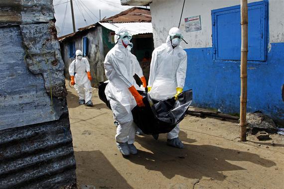 <p>Trabajadores de la salud en Liberia recogen el cuerpo de una víctima de ébola en West Point (Monrovia). / EFE</p>