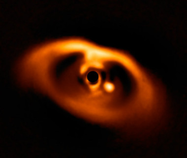 <p>Primera imagen de la formación del planeta PDS 70b, visible como un punto brillante a la derecha del centro de la imagen y que queda oscurecido por la máscara del coronógrafo, que bloquea la intensa luz de la estrella central. / <a href="https://media.eurekalert.org/multimedia_prod/emb/media/174491.jpg" target="_blank">ESO/A. Müller et al.</a></p>