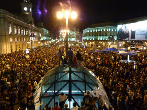 <p>Miles de personas se concentran en la Plaza de Sol en apoyo al movimiento 15-M. Foto: Lecamaleon.</p>